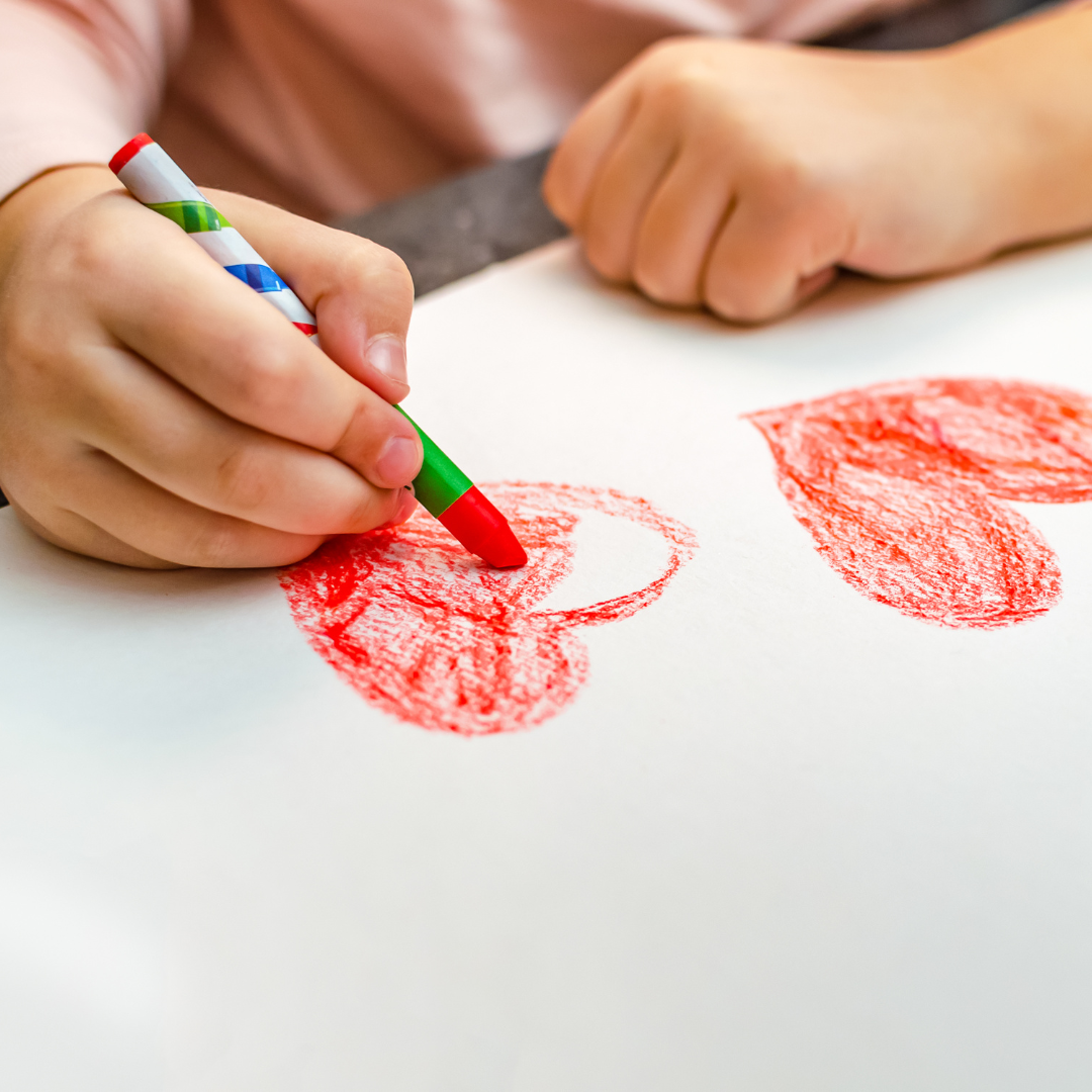 Kids hands drawing a heart