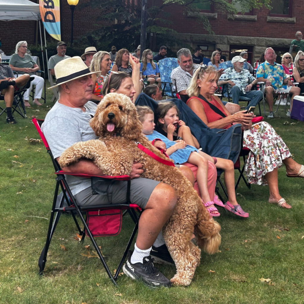 People and dog enjoy the concert